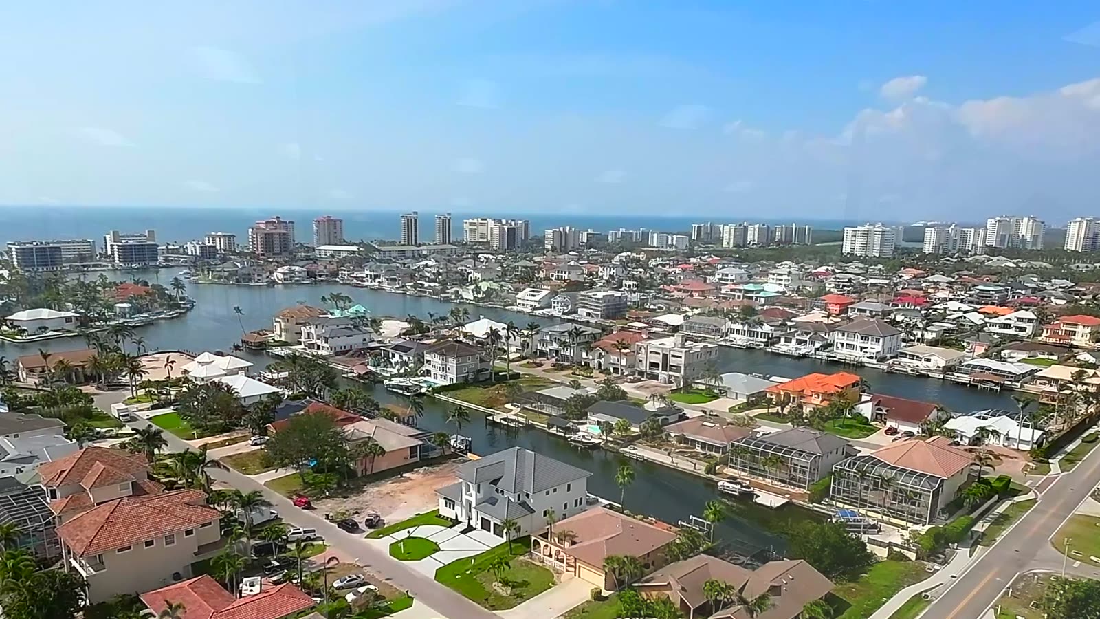 High aerial over Naples waterfront neighbourhoods and marina